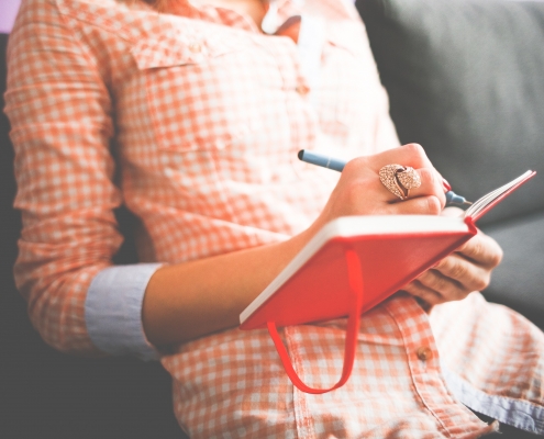 woman journaling to process her emotions, anxiety, and stress
